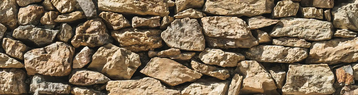 Earth element banner: stone wall built from sun-baked rock representing strong foundations